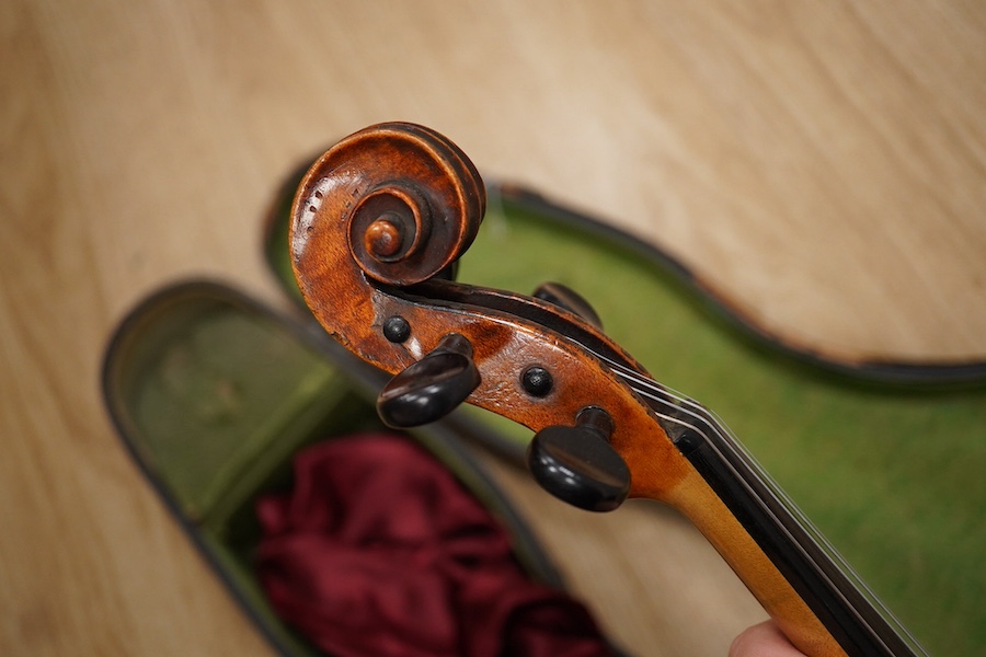 A late 19th century German violin from the Mittenwald region, body length 36cm, in a contemporary case. Condition - fair to good, condition of the case - poor.